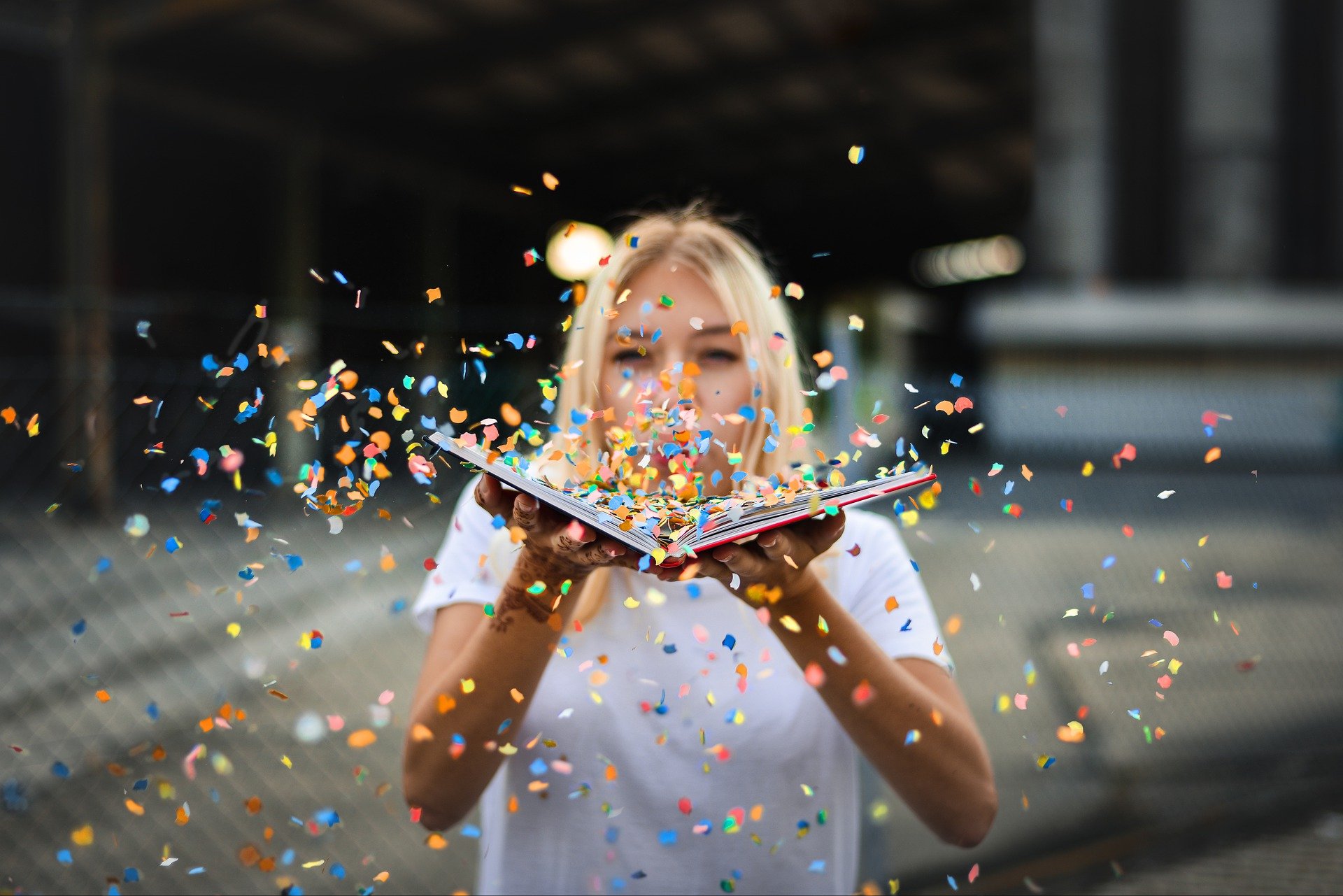 woman with book and confetti