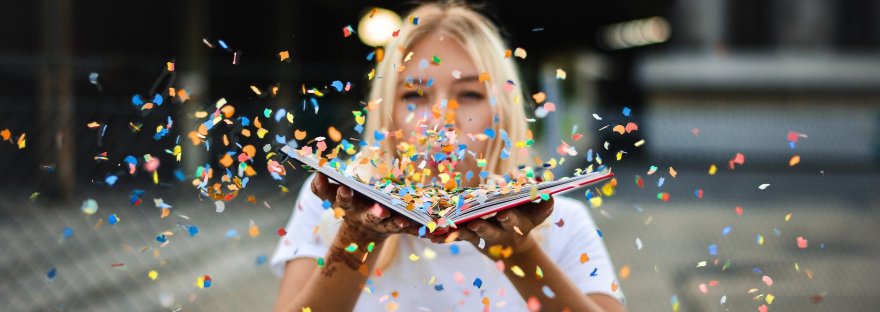 woman with book and confetti