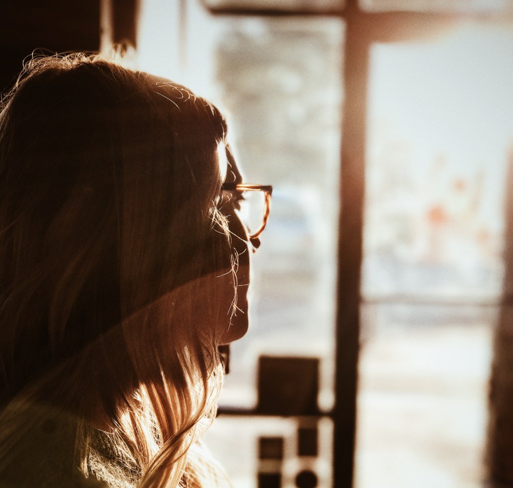woman looking out door