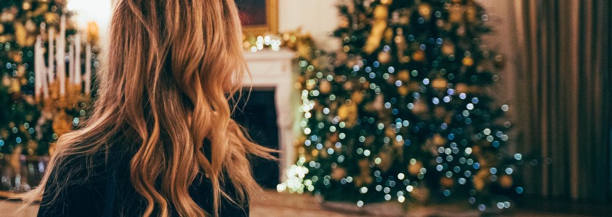 woman looking at Christmas tree